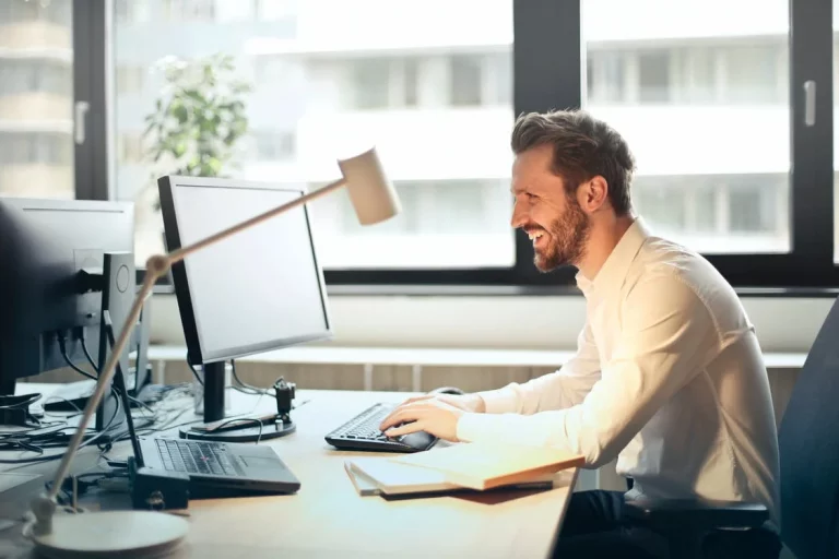 A man in an office, smiling